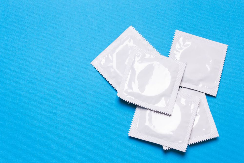 Condoms in packets blue background